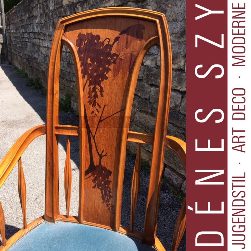 Louis Majorelle, Mahogany, nutwood and fruitwood, polished and with inlays. Upholstered. The backrest with twig-shaped inlays. Height 108cm, height of the seat approx. 46cm.